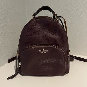 Deep Burgundy Kate Spade backpack. Long adjustable straps and burgundy interior